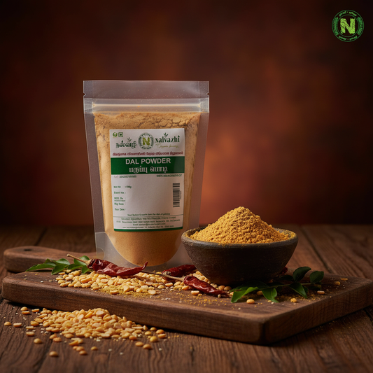 Nalvazhi Dal Powder 100g packet on rustic dark wooden surface with scattered dal and clay bowl