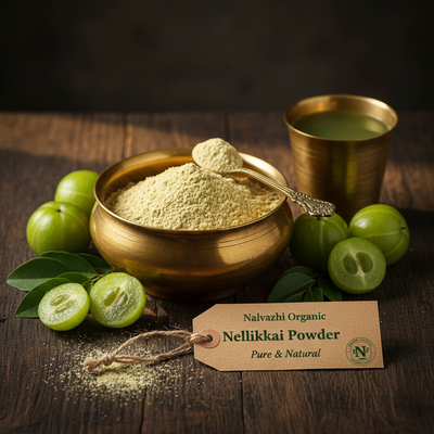 Nellikkai golden-green powder in traditional brass uruli with fresh Indian Gooseberry fruits and brass tumbler of juice