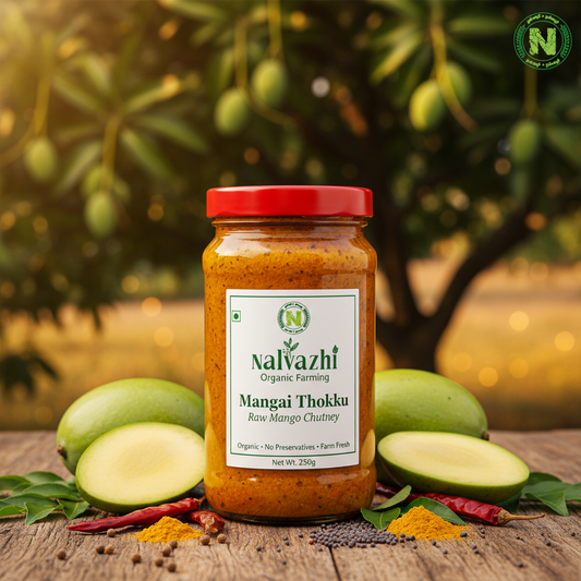 Nalvazhi Mangai Thokku jar with fresh raw mangoes, spices and Nalvazhi label