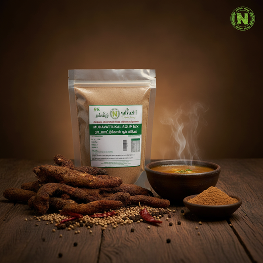 Nalvazhi Mudavattukal Soup Mix packet on rustic dark wooden surface with mudavattukal kizhangu roots and steaming soup bowl