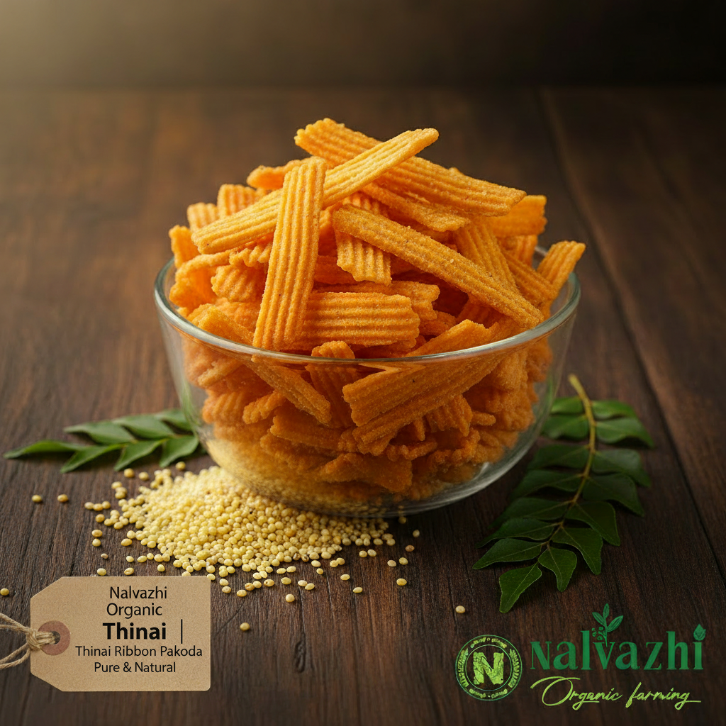 Nalvazhi Organic Thinai Ribbon Pakoda golden orange crispy ribbon strips in clear glass bowl on dark wooden table