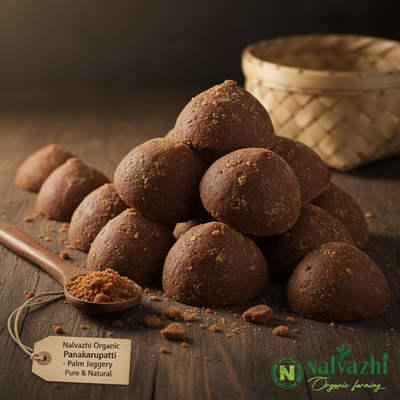 Nalvazhi Organic Panakarupatti dark brown dome-shaped palm jaggery pieces with powdery surface on dark wooden surface with woven palm leaf basket