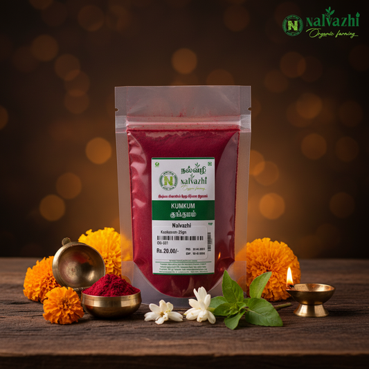 Nalvazhi pure natural kumkum 25g clear packet with deep red kumkum powder surrounded by marigold flowers and glowing brass diya