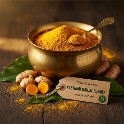 Kasthuri Manjal golden-yellow powder in brass uruli with fresh Wild Turmeric rhizomes and green turmeric leaves