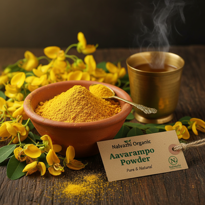 Aavarampoo golden-yellow powder in terracotta bowl with fresh Senna auriculata flowers and brass tumbler of herbal tea