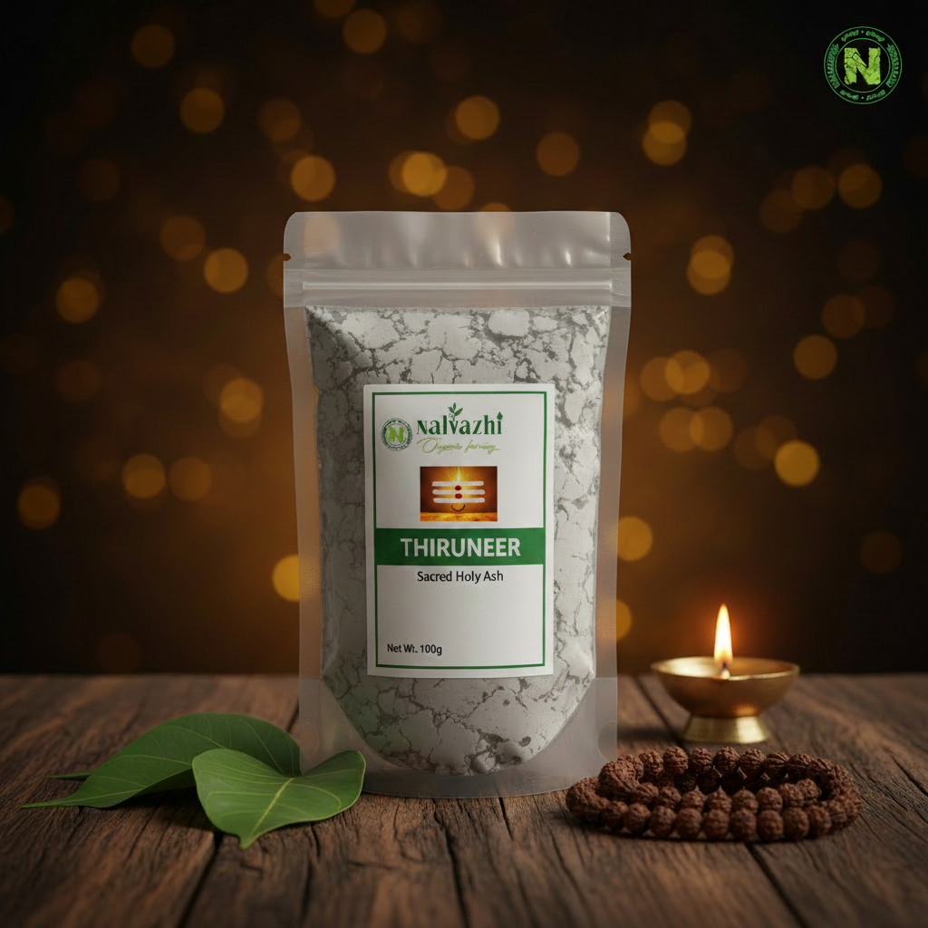 Smooth clear transparent packet of Thiruneer sacred holy ash with elegant Nalvazhi label showing Tripundra image, bilva leaves and glowing brass diya on dark wooden surface