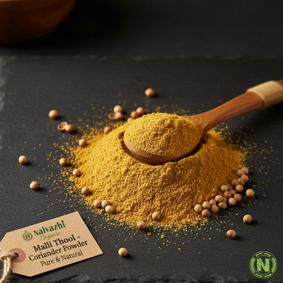 Nalvazhi Organic Malli Thool Coriander Powder on dark slate with wooden spoon