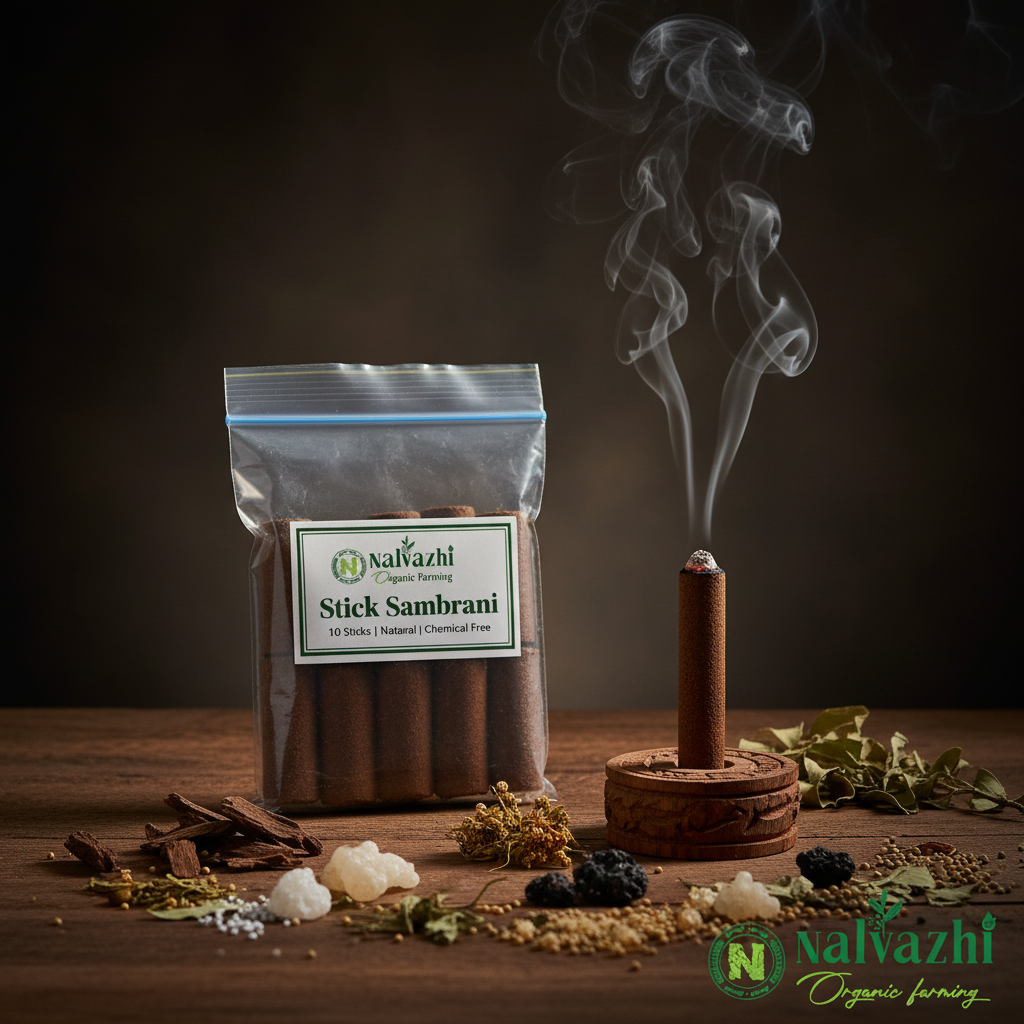 Nalvazhi Stick Sambrani — branded packet with lit brown stick, smoke, and raw ingredients scattered on wooden surface